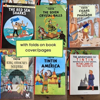 Adventures of Tintin (SINGLES) with dents and folds on book cover and pages