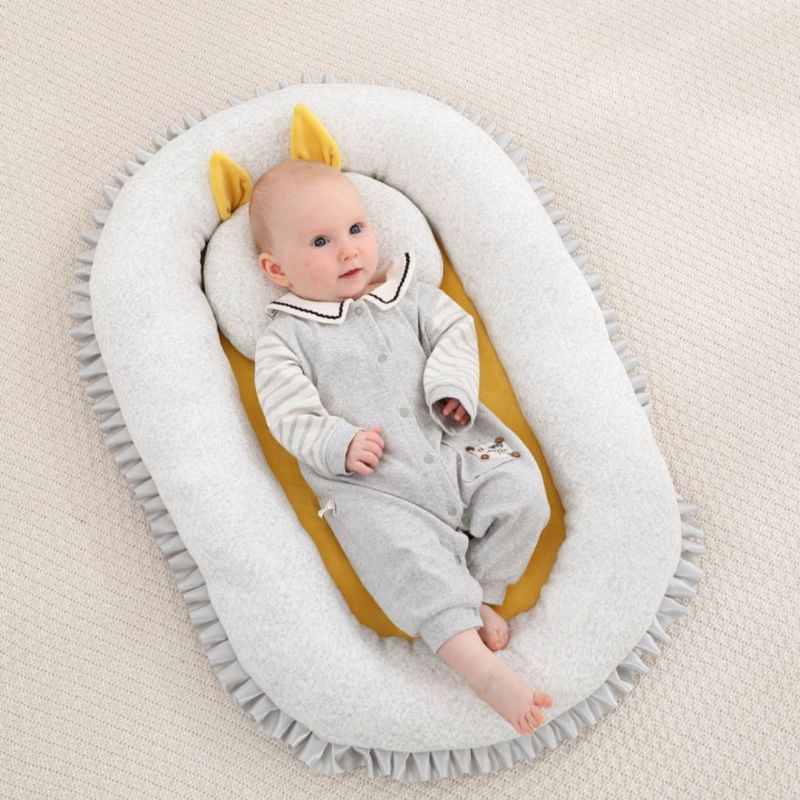 newborn sleeping on boppy lounger