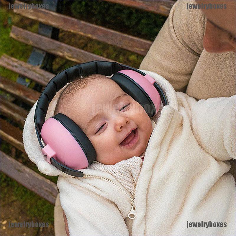 baby with ear muffs