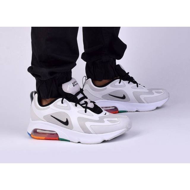 white nikes with rainbow bottom