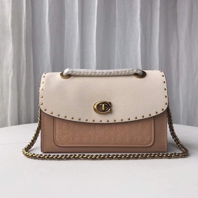 coach parker with rivets and snakeskin detail