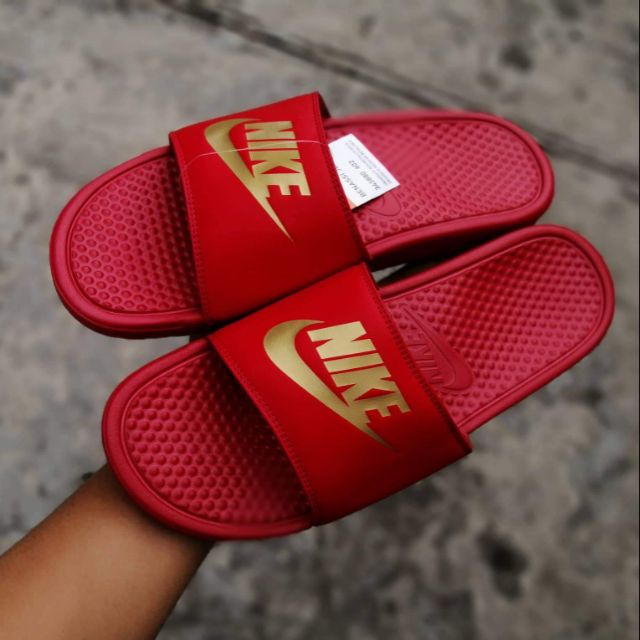 gold and red nike slides