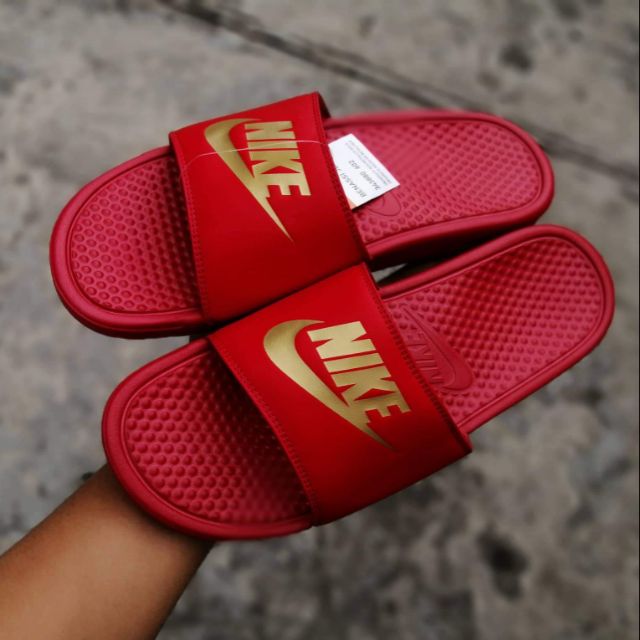 red nike slides with gold check