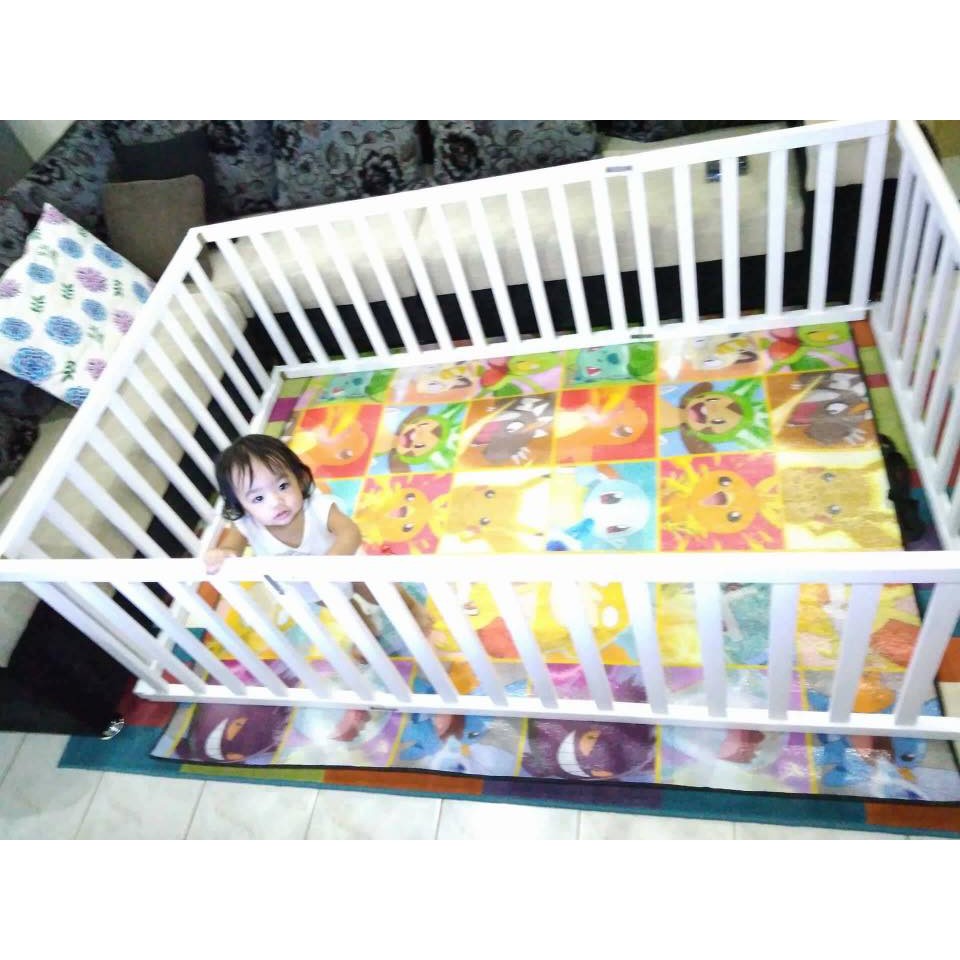 white wooden playpen