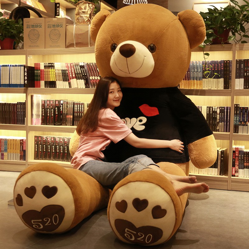 girl hugging huge teddy bear