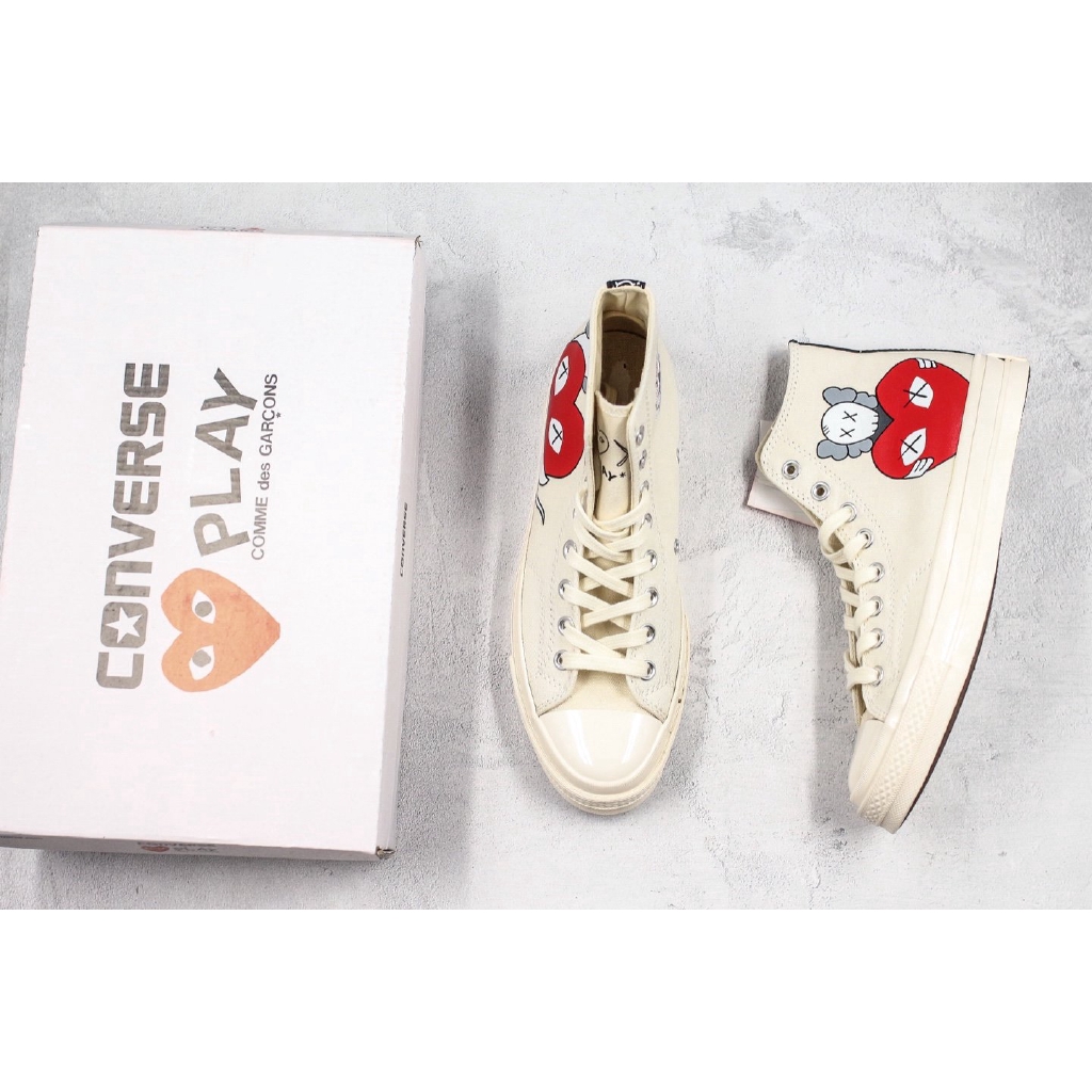 cdg x kaws
