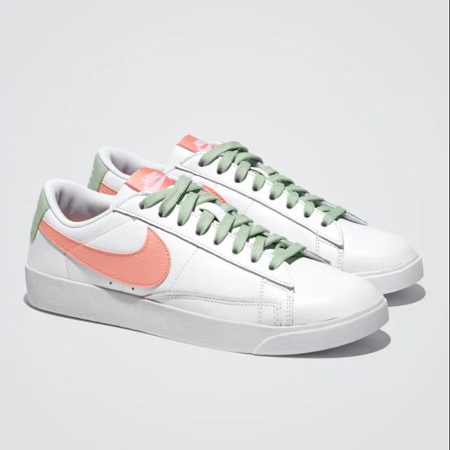 white and coral nike shoes