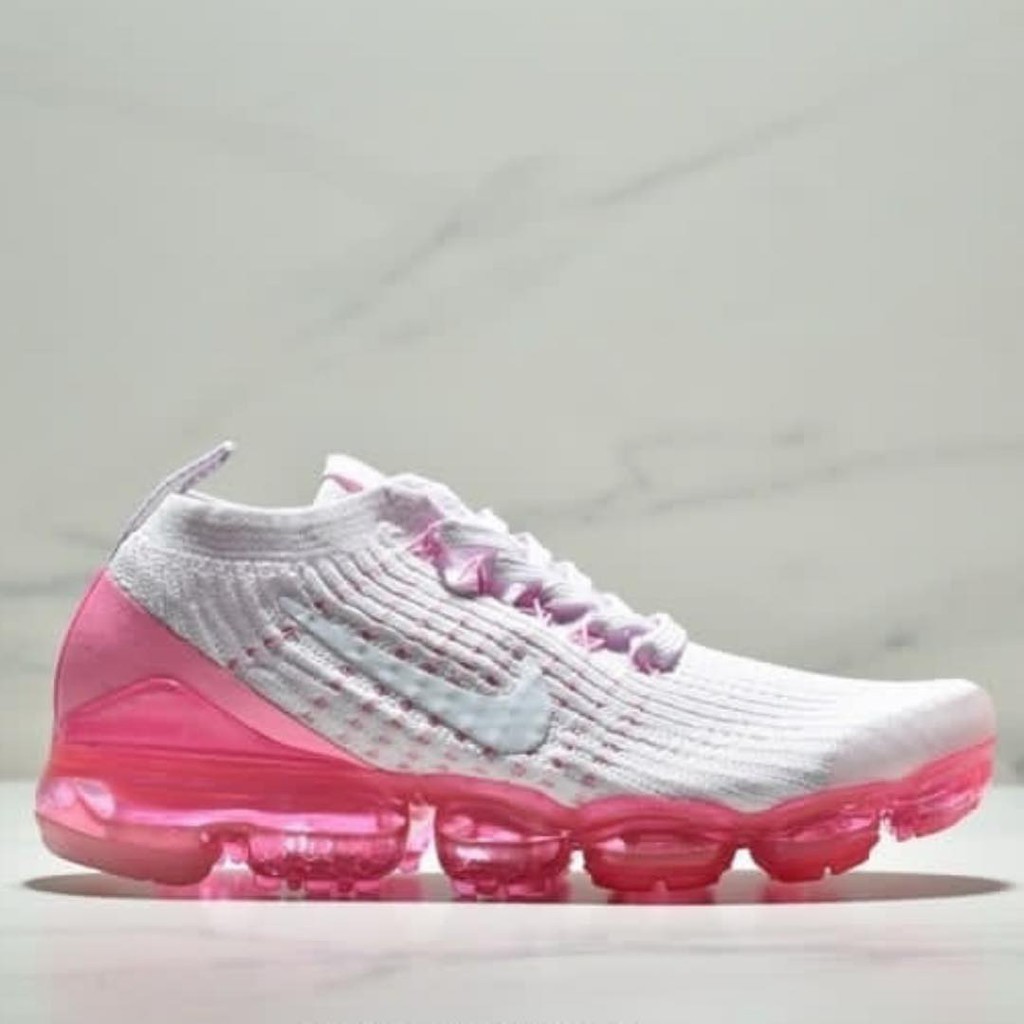 white and pink running shoes