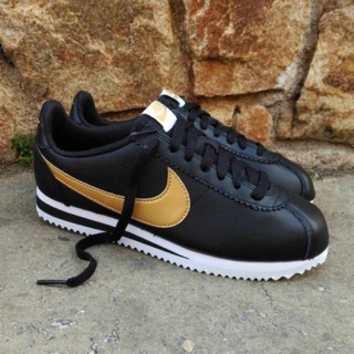 black nike cortez with gold swoosh