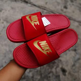 gold and red nike flip flops