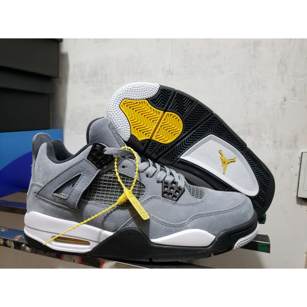 black and yellow jordan 4