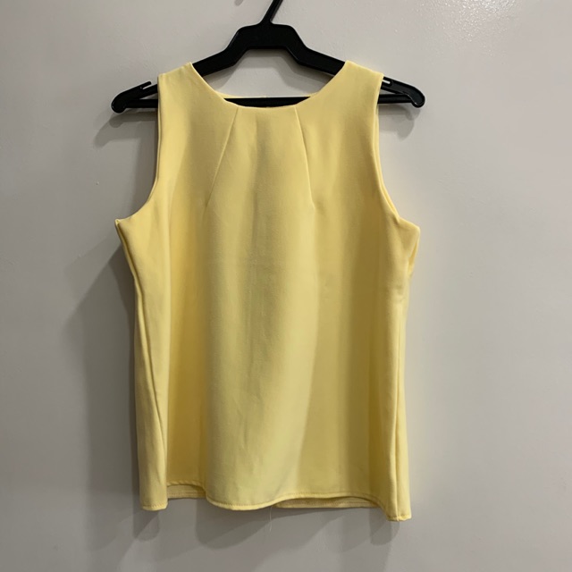 sleeveless yellow blouse