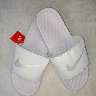 white and silver nike slides