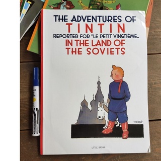 Adventures of Tintin (SINGLES) with dents and folds on book cover and pages