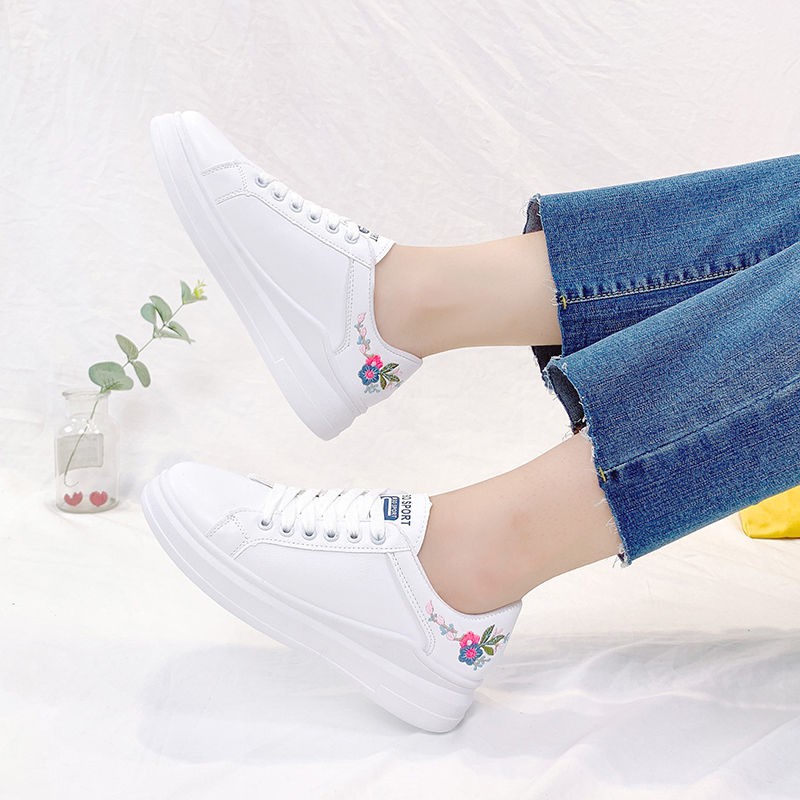 white shoes with flower embroidery