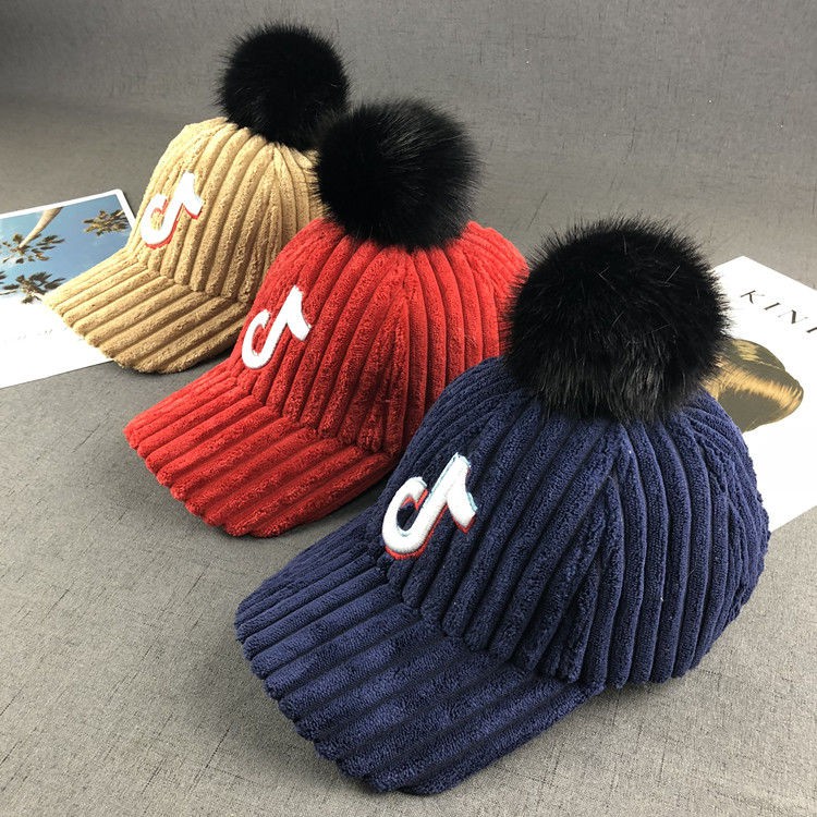 baseball hat with fur ball