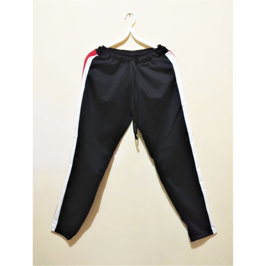white joggers with red stripe