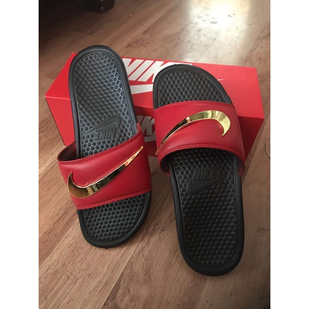 burgundy nike flip flops with gold check