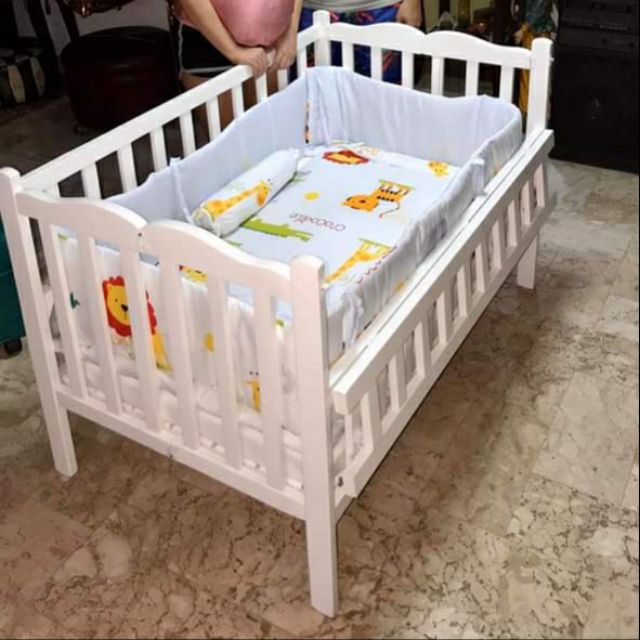 white wooden baby crib