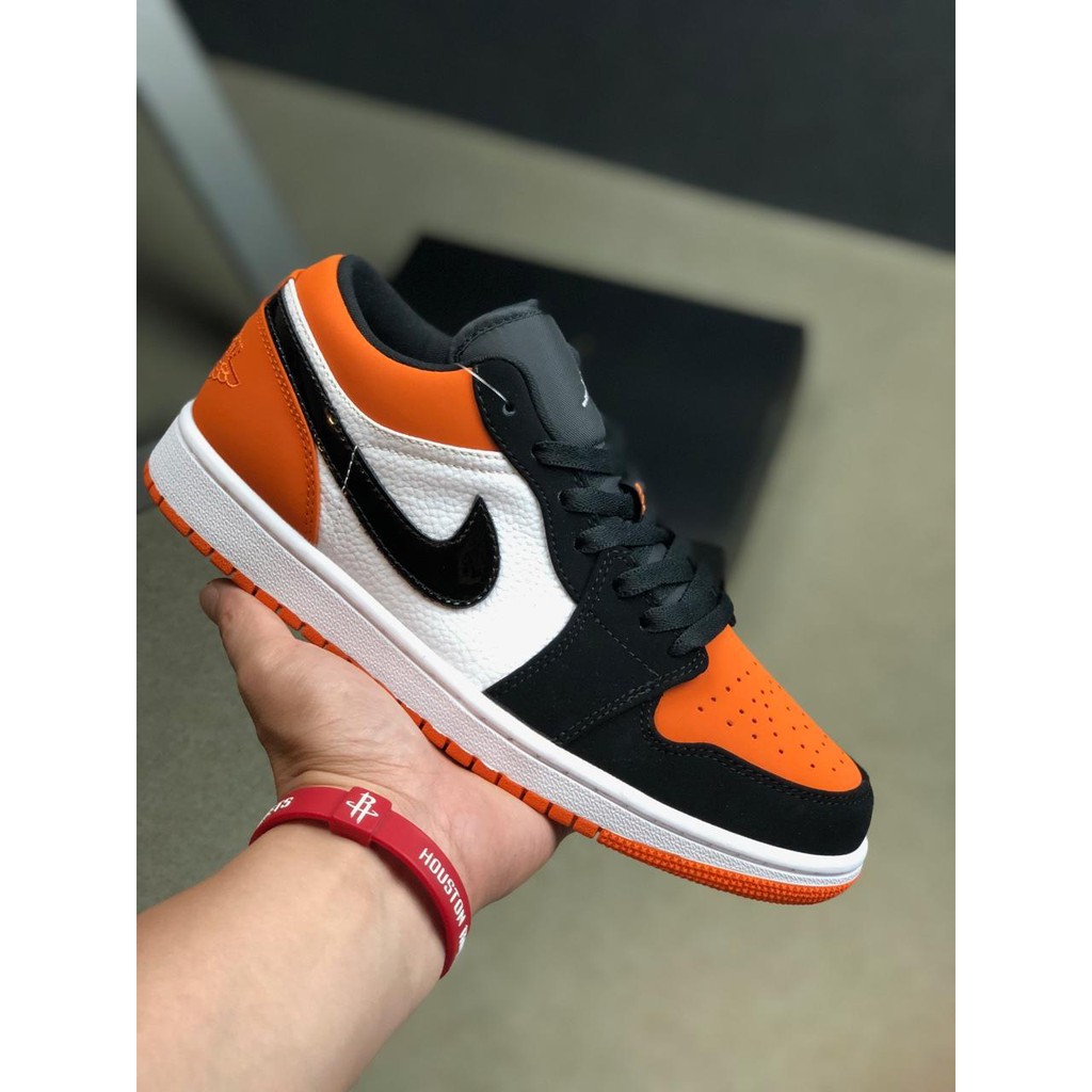 orange and black jordans low top