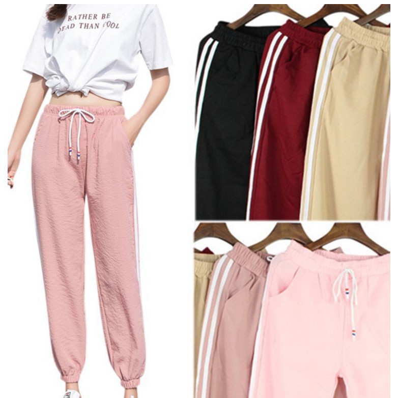 pink joggers with white stripe