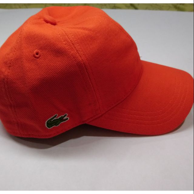 orange lacoste hat