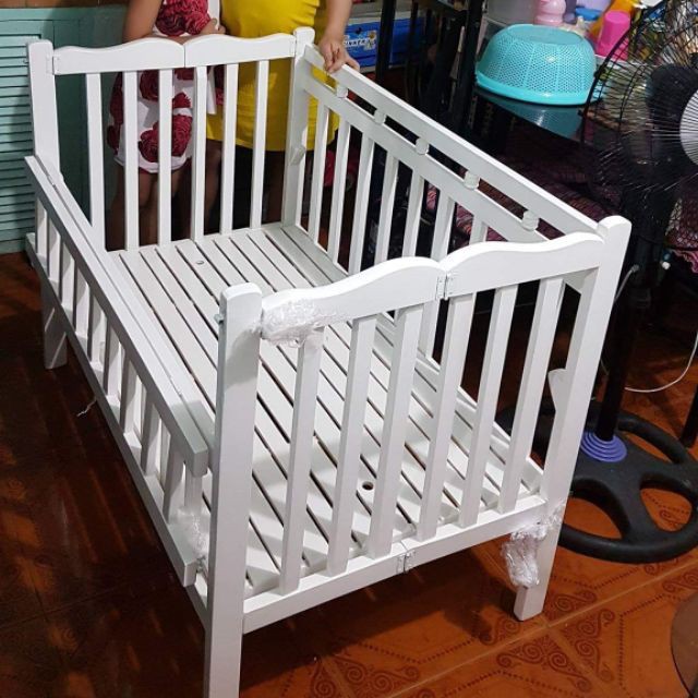 white wooden cradle