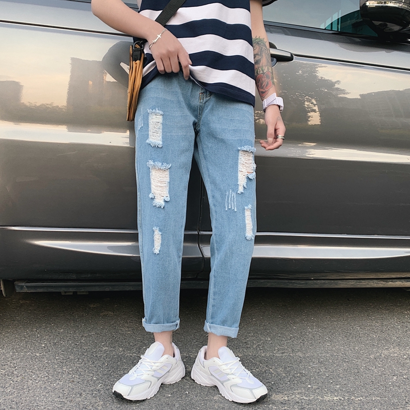 light blue jeans with holes