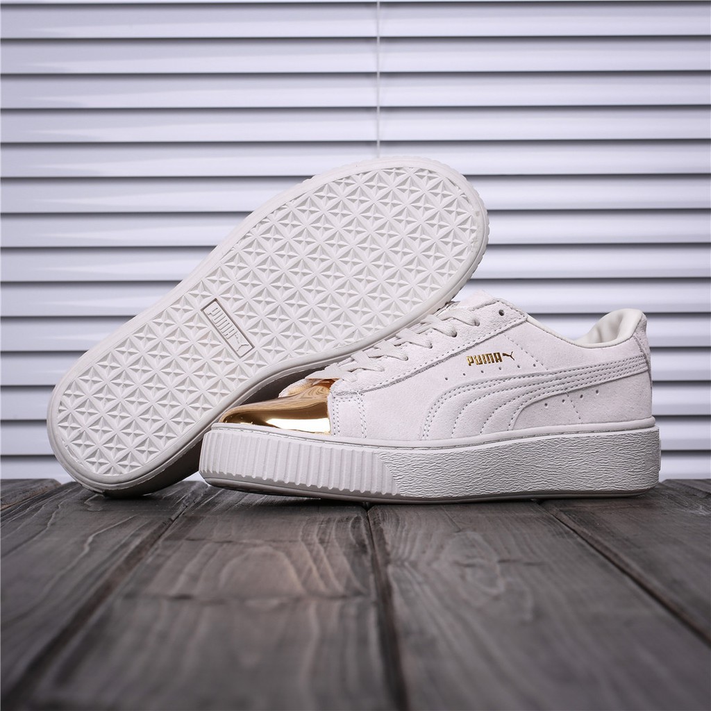 white and gold puma shoes