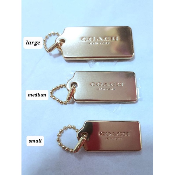 Coach gold metal hang tag clearance