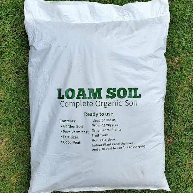 Bag of loam soil organic compost for healthy garden and colorful plants ...